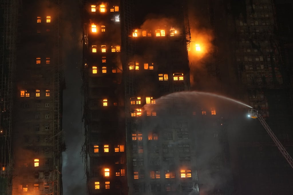 Water from a fire truck is sprayed on the blaze at Wang Fuk Court at Tai Po. Photo: Sam Tsang