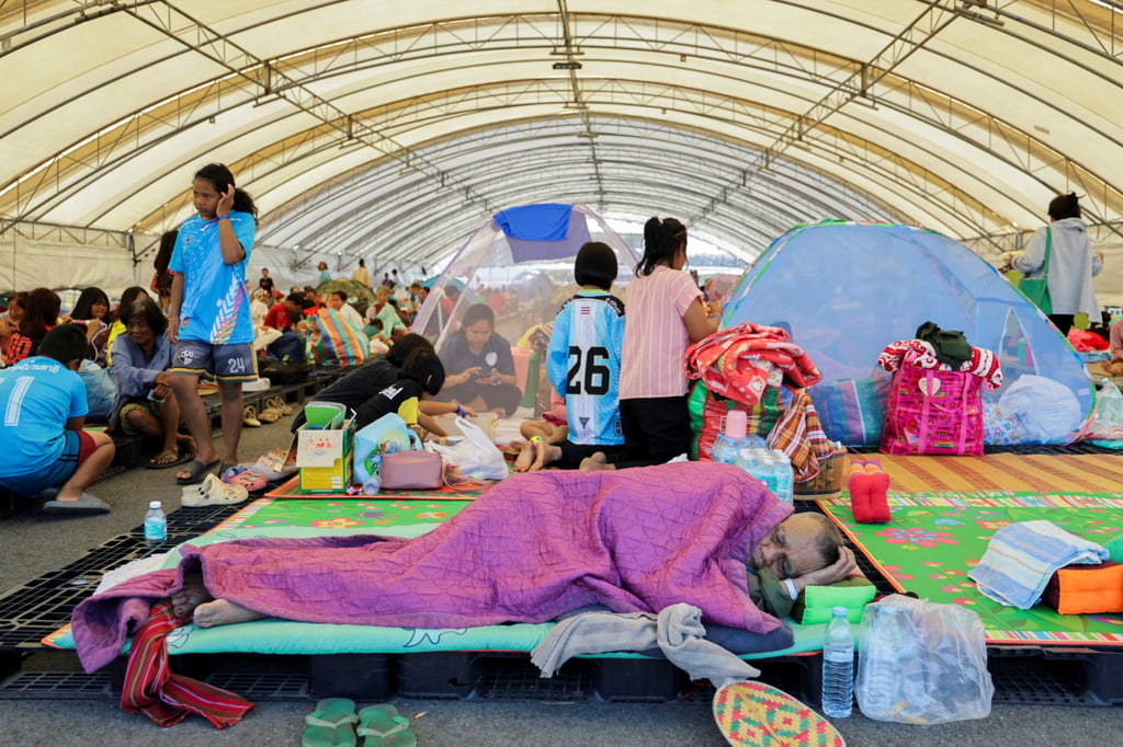 People rest at a shelter in Thailand’s Buriram province on Monday following fresh military clashes between Thailand and Cambodia along parts of their disputed border. Photo: Reuters