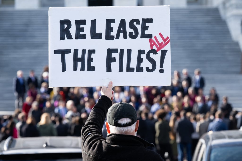 A protester holds a sign related to the release of the Jeffrey Epstein case files outside the US Capitol in Washington, last month. Photo: TNS