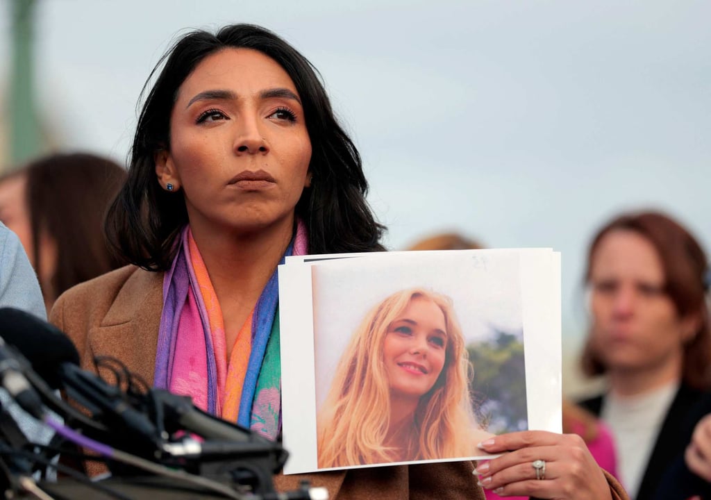 Amanda Roberts, sister-in-law of Virginia Giuffre, holds up a photo of Giuffre during a news conference with US lawmakers in Washington in November. Photo: AFP