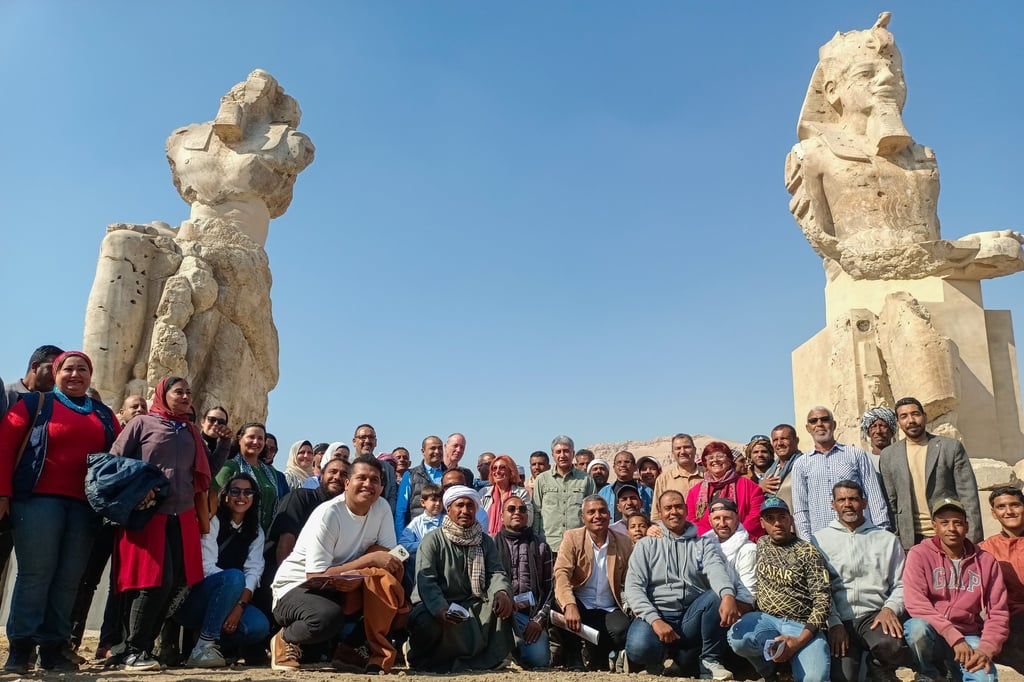 Sherif Fathy, Egypt’s tourism and antiquities minister, centre, with antiquity workers in front of the alabaster statues of ancient Egyptian King Amenhotep III, in Luxor on Sunday. Photo: EPA