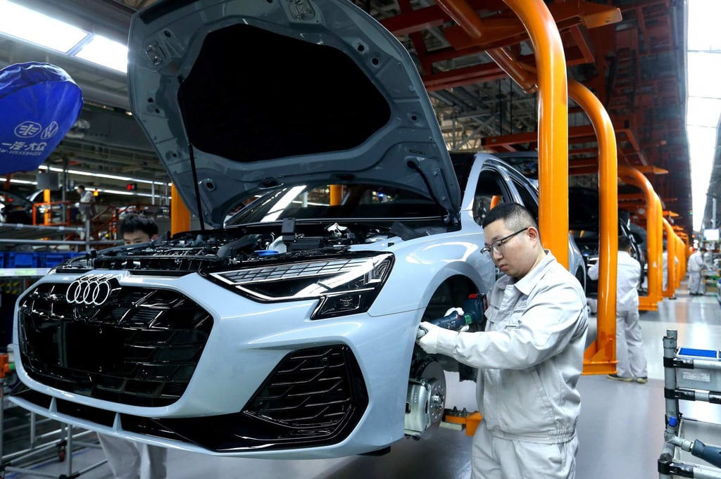 Workers are seen at a Volkswagen plant in Qingdao, China, on Tuesday. Photo: AFP