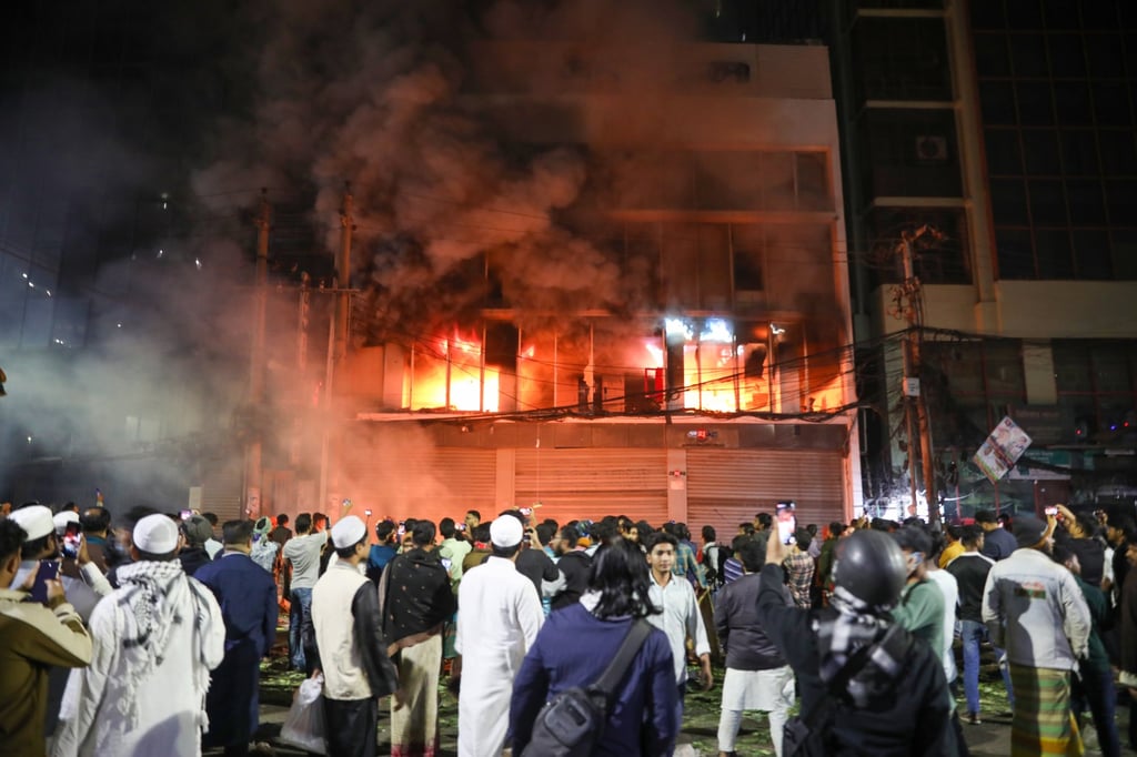 Protesters set fire to a newspaper’s offices on Friday in Dhaka. Photo: EPA