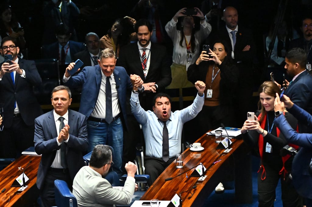 Brazilian opposition lawmakers celebrate during a Senate session in Brasilia on Wednesday. Photo: EPA