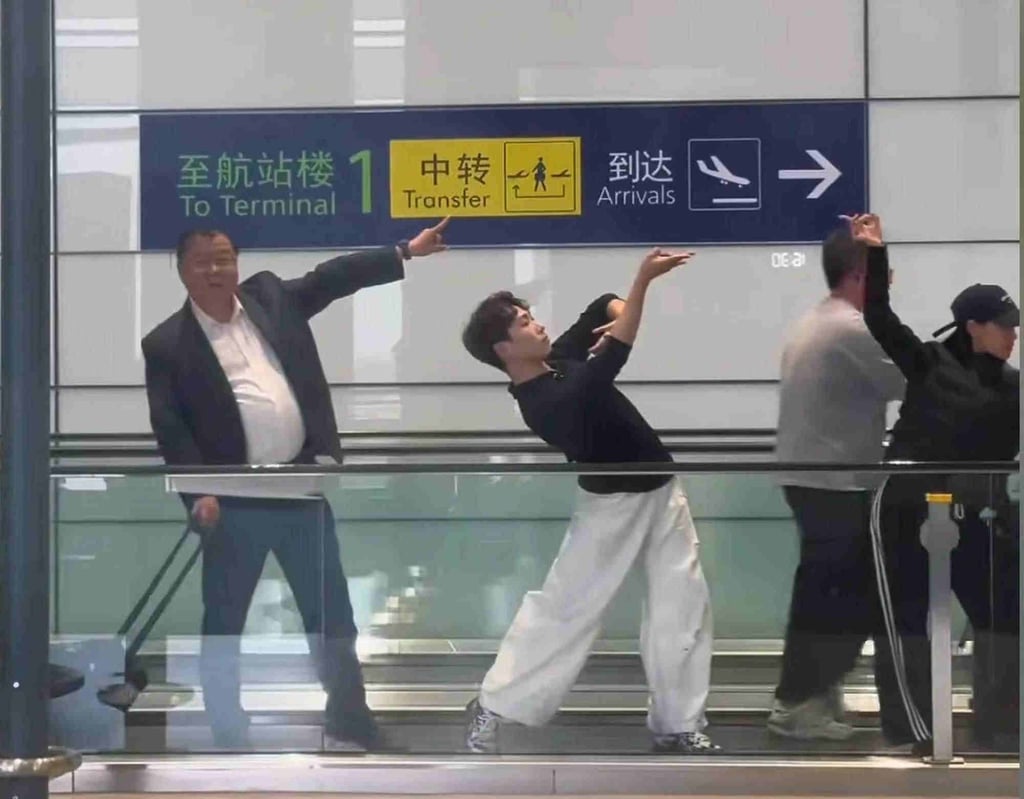 A portly Fu, far left, muscles in on the professional dance action on the airport walkway. Photo: QQ.com