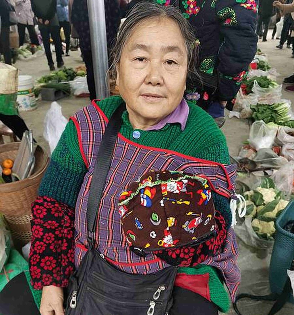 A woman shows off a “dog-head hat” which was crafted by hand. Photo: wldsb.com