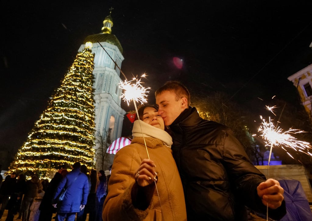 A couple kiss during a New Year celebrations in Kyiv, Ukraine. Photo: Reuters