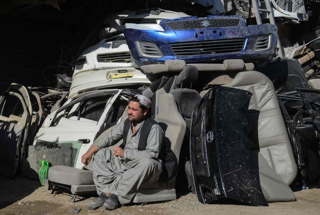 A man sits outside an auto parts shop at a market near the Afghanistan-Pakistan border in Spin Boldak. Photo: AFP