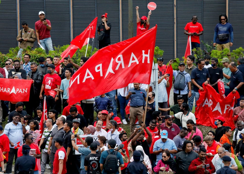 Anwar Ibrahim’s supporters hold Pakatan Harapan flags in Kuala Lumpur in November 2022. The next general election must be held by early 2028 at the latest. Photo: Reuters