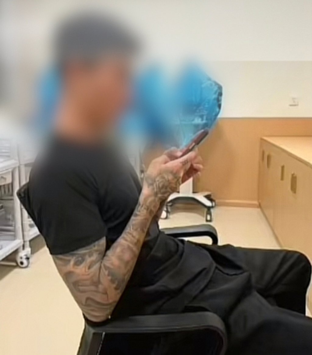 Footage shared online showed the woman’s boyfriend, above, on his mobile phone inside the hospital. Photo: gscn.com.cn