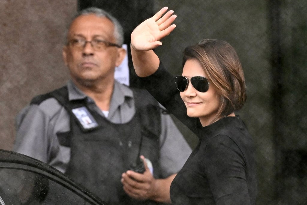 Michelle Bolsonaro, wife of Brazil’s ex-president Jair Bolsonaro, waves at supporters outside the Federal Police headquarters in Brasilia, where her husband is being held, during a visit in November. Photo: AFP