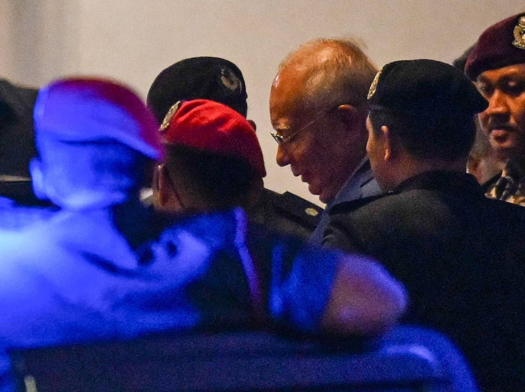 Former Malaysian prime minister Najib Razak (centre) leaves the court after his verdict in the 1MDB trial on December 26. Photo: AFP