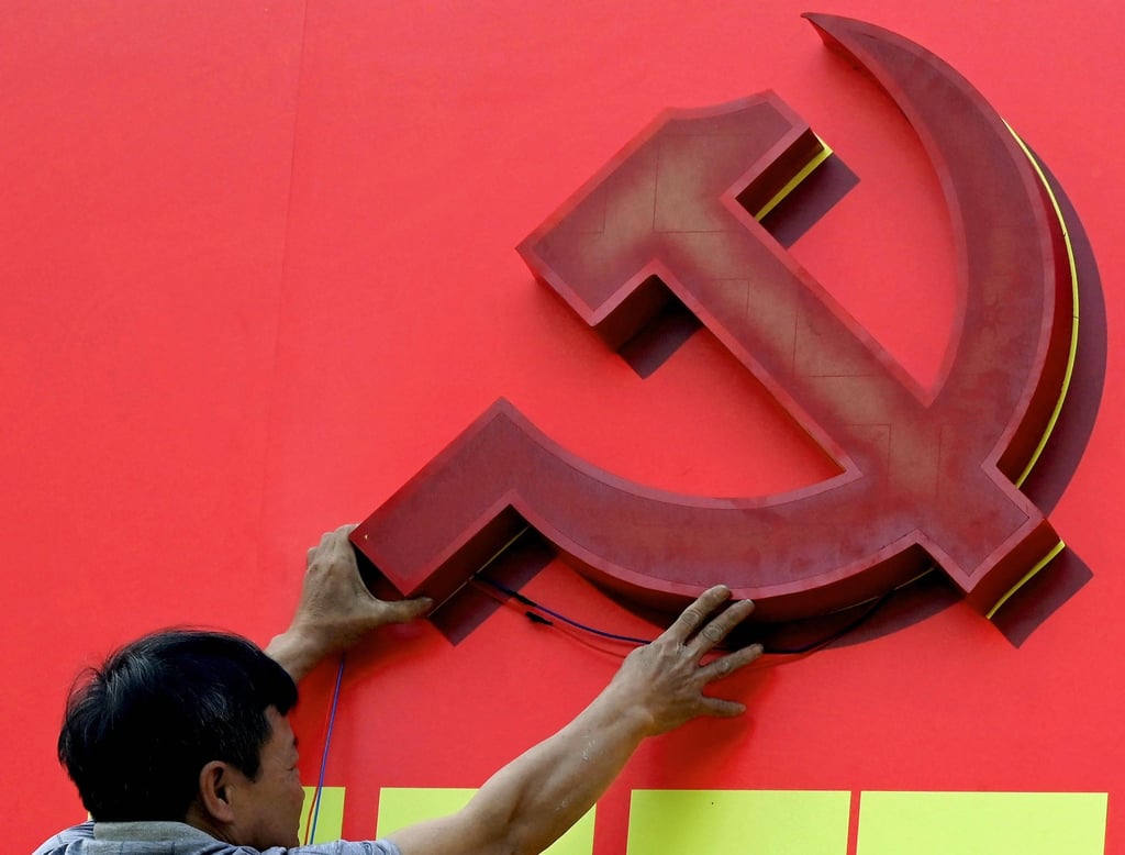 A worker installs a billboard advertising the 14th Congress of the Vietnamese Communist Party in Hanoi on January 9. Photo: AFP