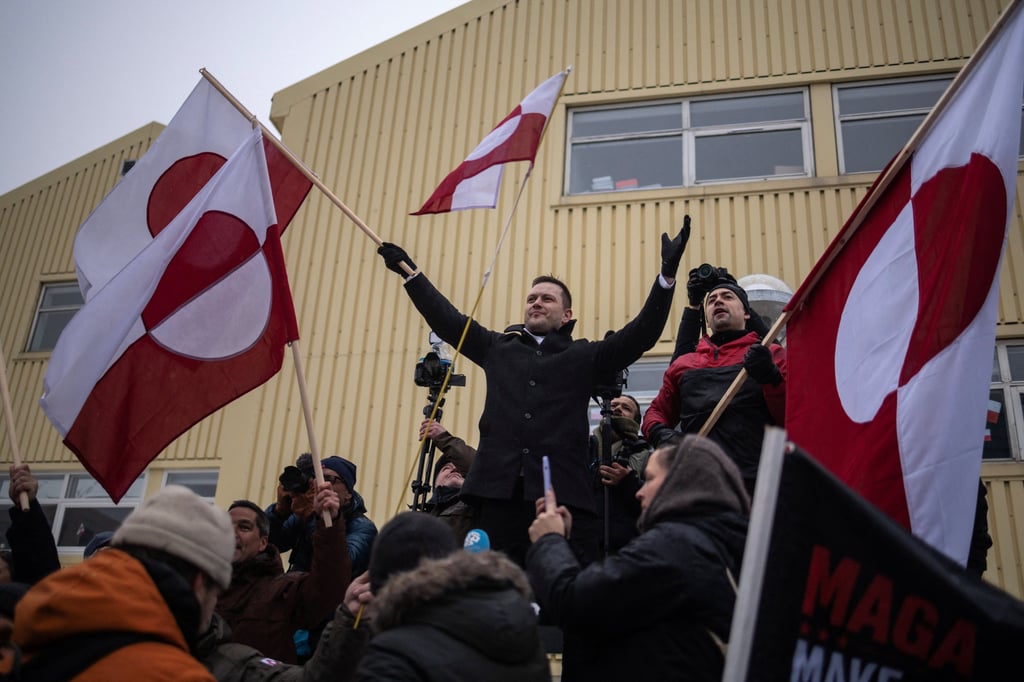 Greenland’s Prime Minister Jens-Frederik Nielsen waves a flag during tha protest on Saturday in Nuuk against US President Donald Trump’s demand that the Arctic island be ceded to the US. Photo: Reuters