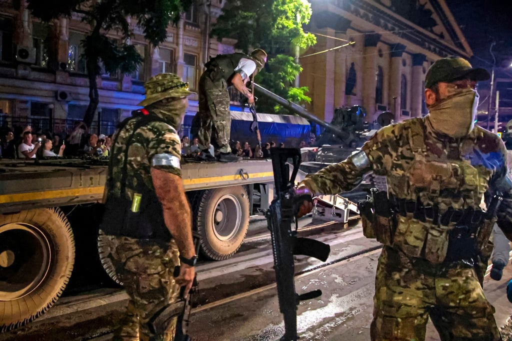 Members of Russia’s Wagner Group guard an area as others load a tank onto a truck in Rostov-on-Don, Russia, on June 24, 2023, during the group’s aborted uprising against Moscow. The mercenary force has been active in the war in Ukraine. Photo: AP