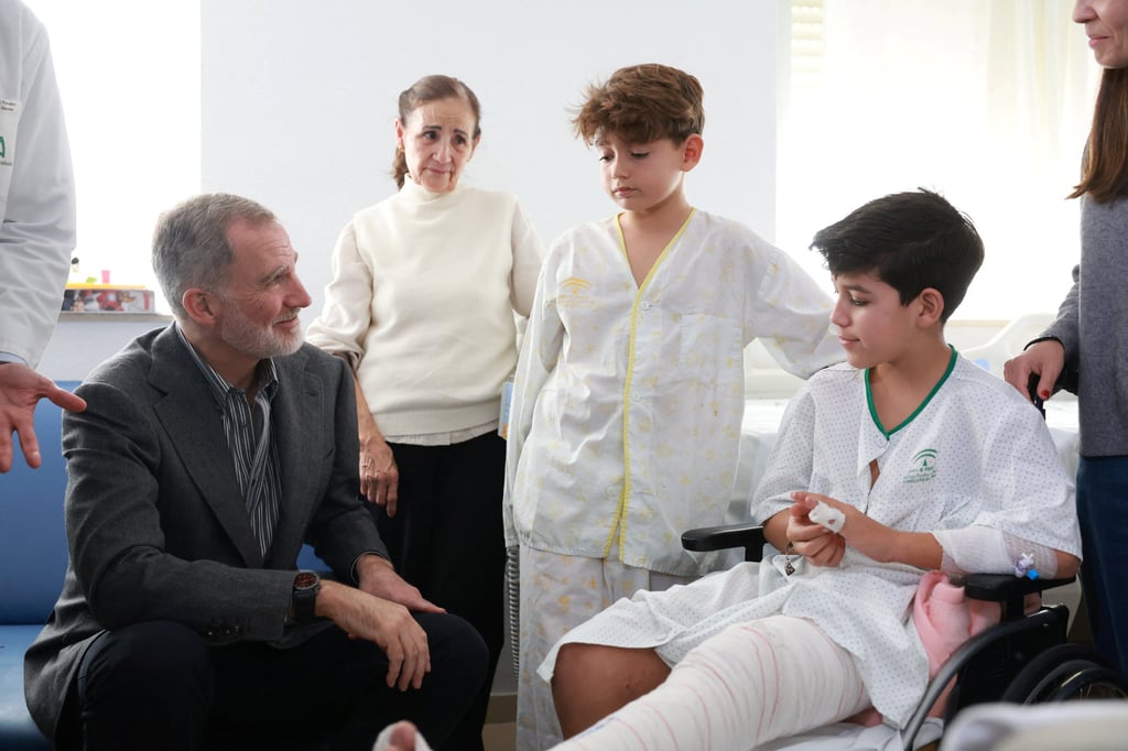 Spain’s King Felipe speaks with two injured children during his visit to the Reina Sofia Hospital in Cordoba, Spain, on Tuesday. Photo: Reuters