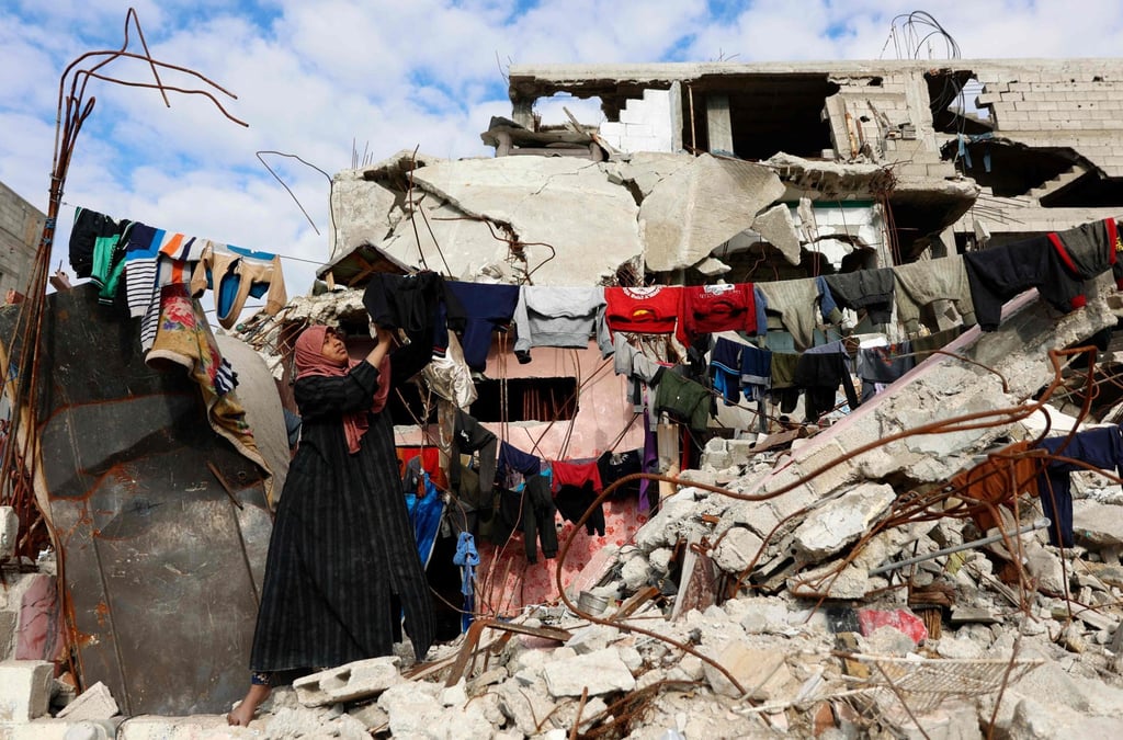 A displaced Palestinian hangs out laundry in the Jabalia refugee camp, northern Gaza Strip, on Saturday. Photo: AFP
