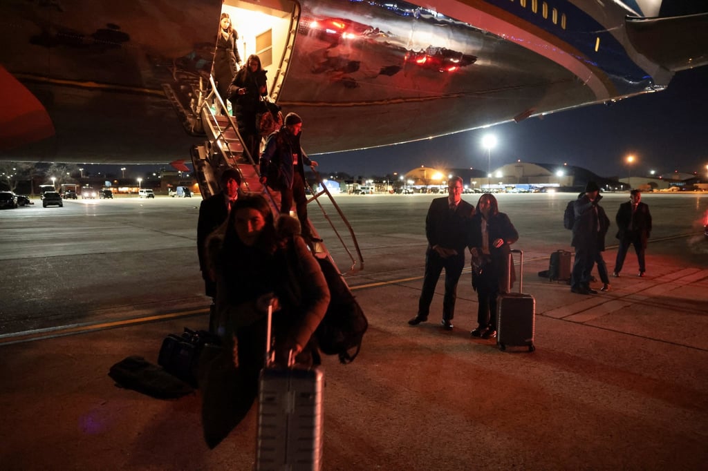 Members of the media deboard Air Force One after returning to Joint Base Andrews. Photo: Reuters