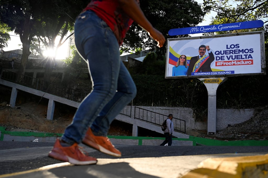 A billboard in Guarenas, Venezuela, featuring ousted president Nicolas Maduro and his wife, Cilia Flores, reading ‘We want them back’. Photo: Reuters