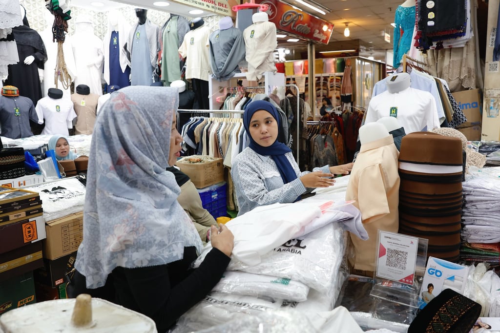 Customers shop for clothes at a shopping centre in Jakarta on Tuesday. Indonesia has been described as a “global bright spot with strong economic growth”, according to President Prabowo Subianto. Photo: EPA