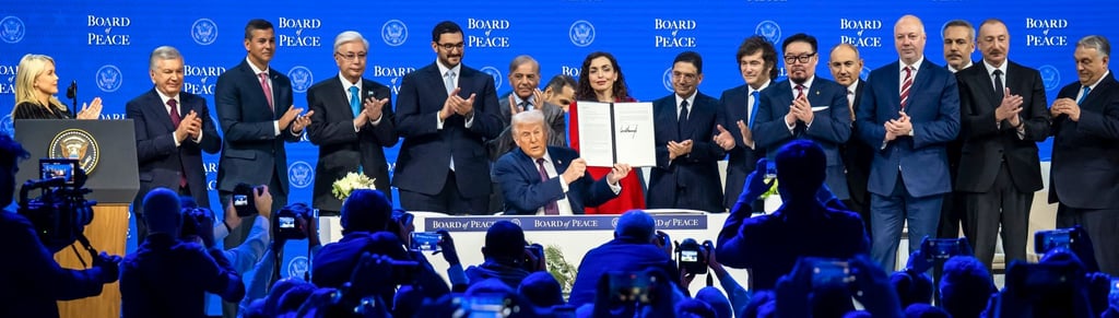 US President Donald Trump holds up the signed “Board of Peace” charter on Thursday. Photo: EPA