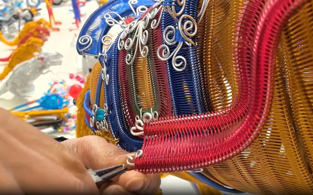 Yang puts the final touches to his work of colourful work of art. Photo: ChinaNews