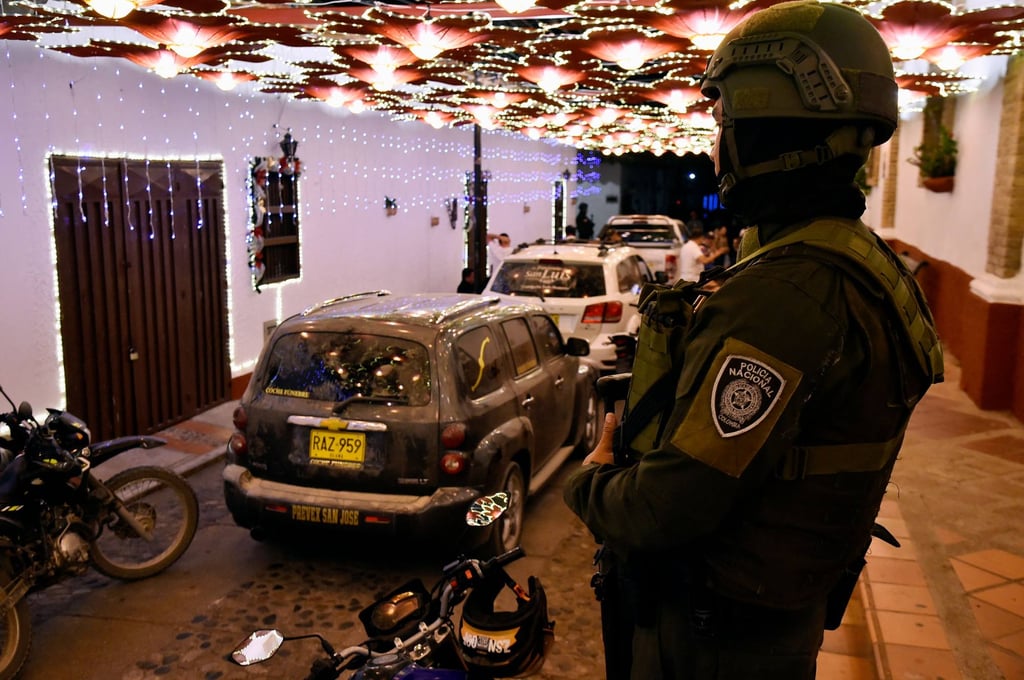 Funeral hearses carrying the bodies. Photo: AFP