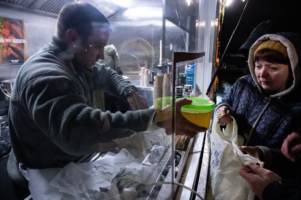 Ukraine veterans serve free hot meals to people without power in their homes in Kyiv on Tuesday. Photo: AP