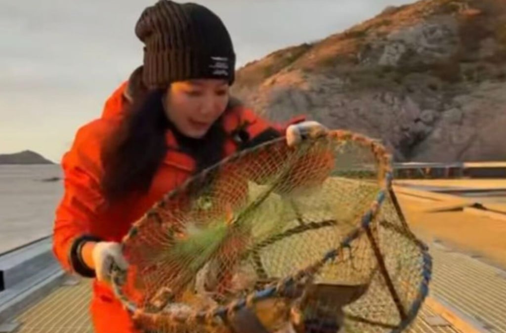 Quality inspector Yue Li checks one of the cages she uses to catch fish and crabs. photo: dskbhz