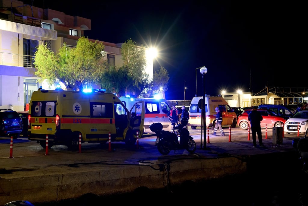 Ambulances prepare to transport the injured at a port in Chios Island, Greece, on Tuesday. Photo: EPA