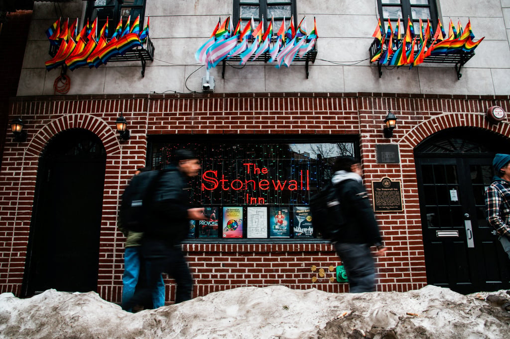 People walk past The Stonewall Inn on Tuesday, after authorities removed the Pride flag from the Greenwich Village site of the Stonewall National Monument. Photo: Reuters