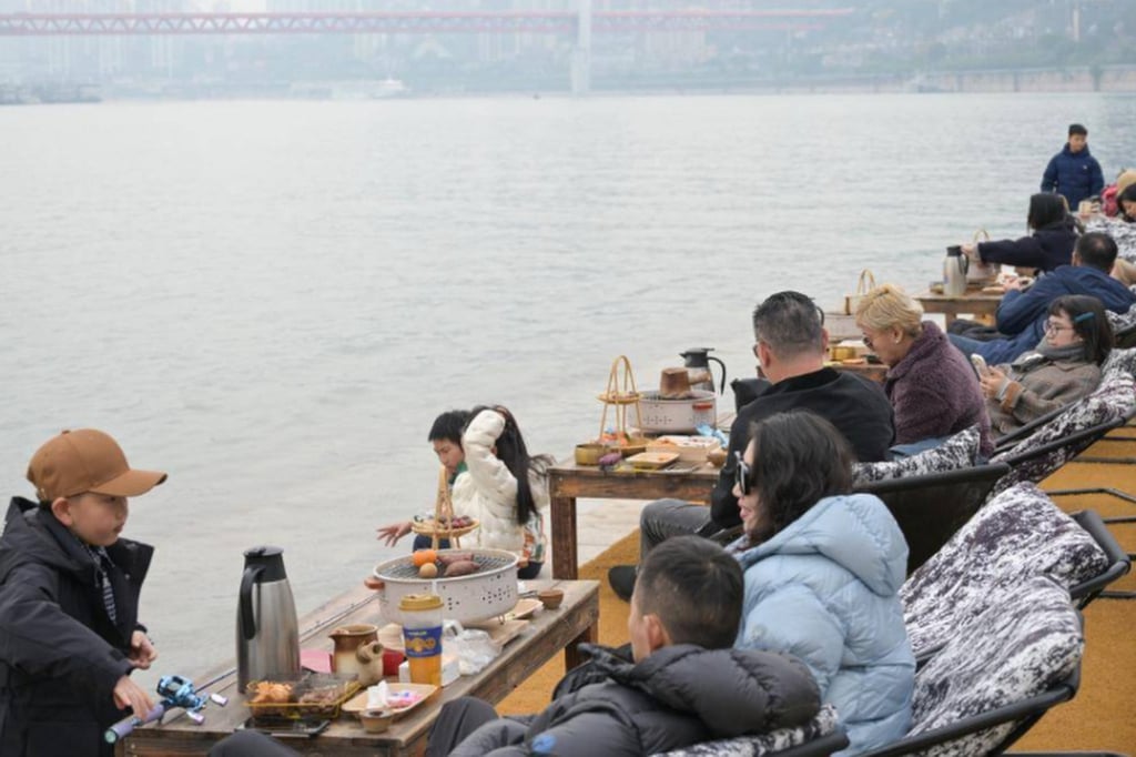 Young people in China pictured taking things easy by the side of a river. A far cry from the hedonism of past years. Photo: yam.com