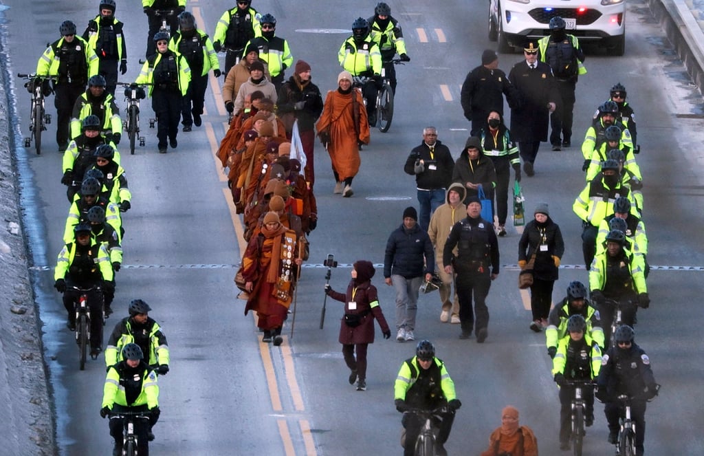 Buddhist monks cross Chain Bridge over the Potomac River between Arlington, Virginia, and Washington on Tuesday. Photo: AFP