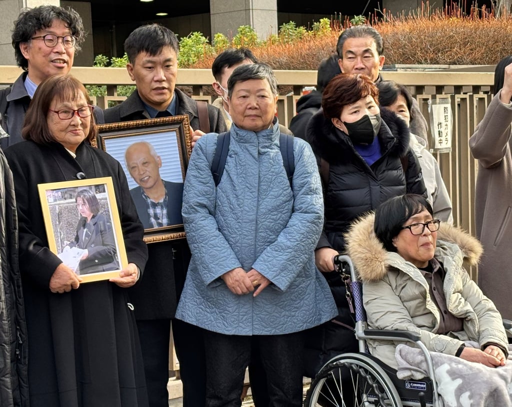 Plaintiffs, their lawyers and supporters gather outside the Tokyo District Court after it ordered North Korea to pay damages for luring Japanese to the North with false promises on January 26. Photo: AP