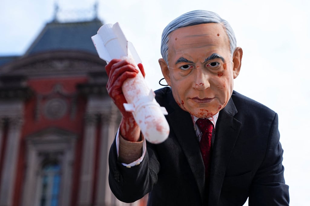 A person wearing a mask depicting Israeli Prime Minister Benjamin Netanyahu takes part in a protest in Washington on Wednesday. Photo: Reuters