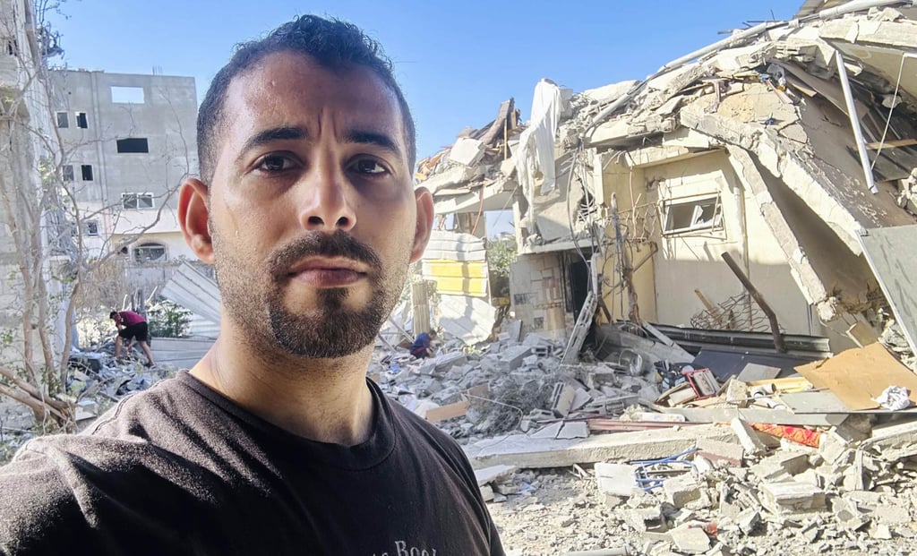 Mosab Abu Toha stands in front of his destroyed home in the Gaza Strip in November 2023. Photo: Mosab Abu Toha