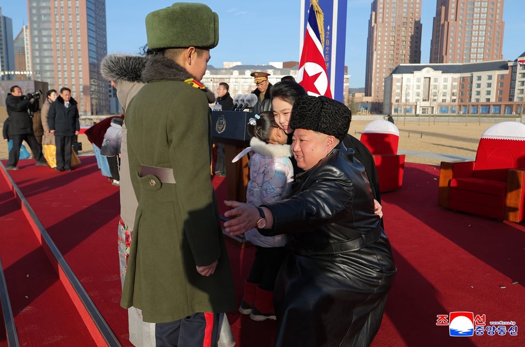 North Korean leader Kim Jong-un (right) and his daughter, Kim Ju-ae (second from right), greeting bereaved family members during the opening ceremony of Saeppyol Street on Sunday. Photo: EPA/KCNA
