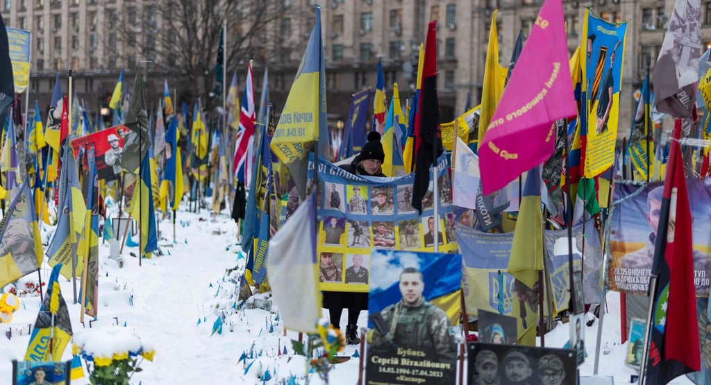A woman looks at a makeshift memorial to fallen Ukrainian and foreign soldiers at Independence Square, central Kyiv, on Tuesday. Photo: AFP