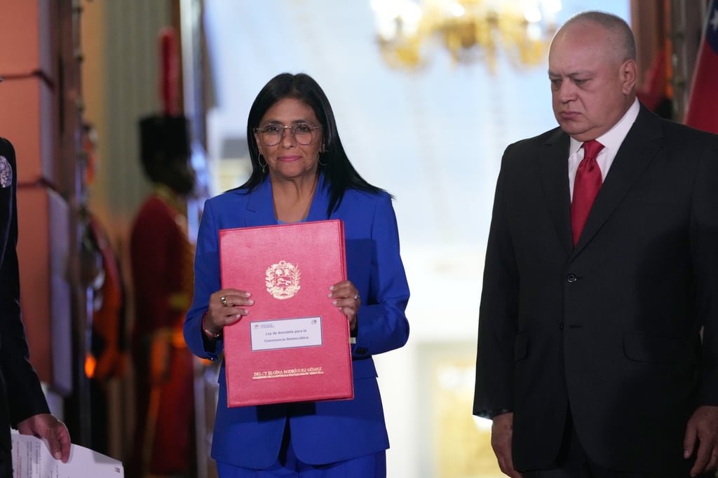 Venezuela’s acting president Delcy Rodriguez holds the amnesty bill. Photo: AP
