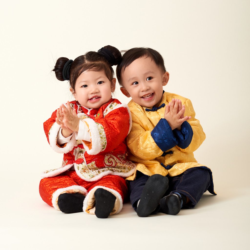 A Chinese baby girl and boy dressed up in traditional outfits for the annual festivities. Photo: Getty Images