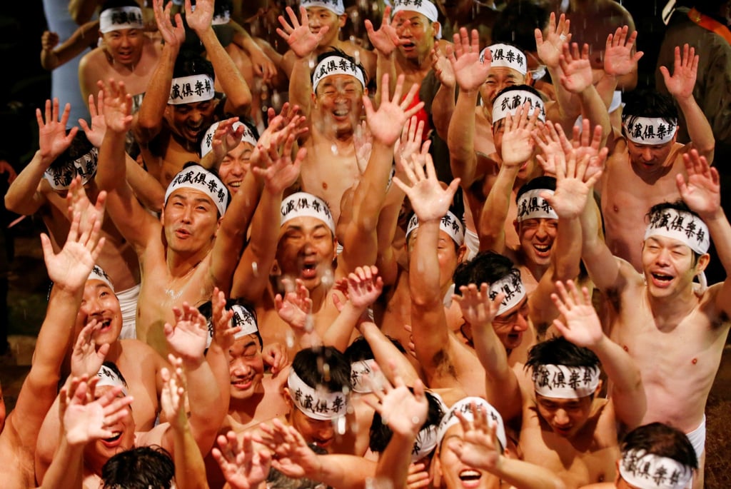 Men in loincloths are doused with water before competing for a sacred wooden stick, or shingi, at the “naked festival” at Saidaiji Temple in 2020. Photo: Reuters