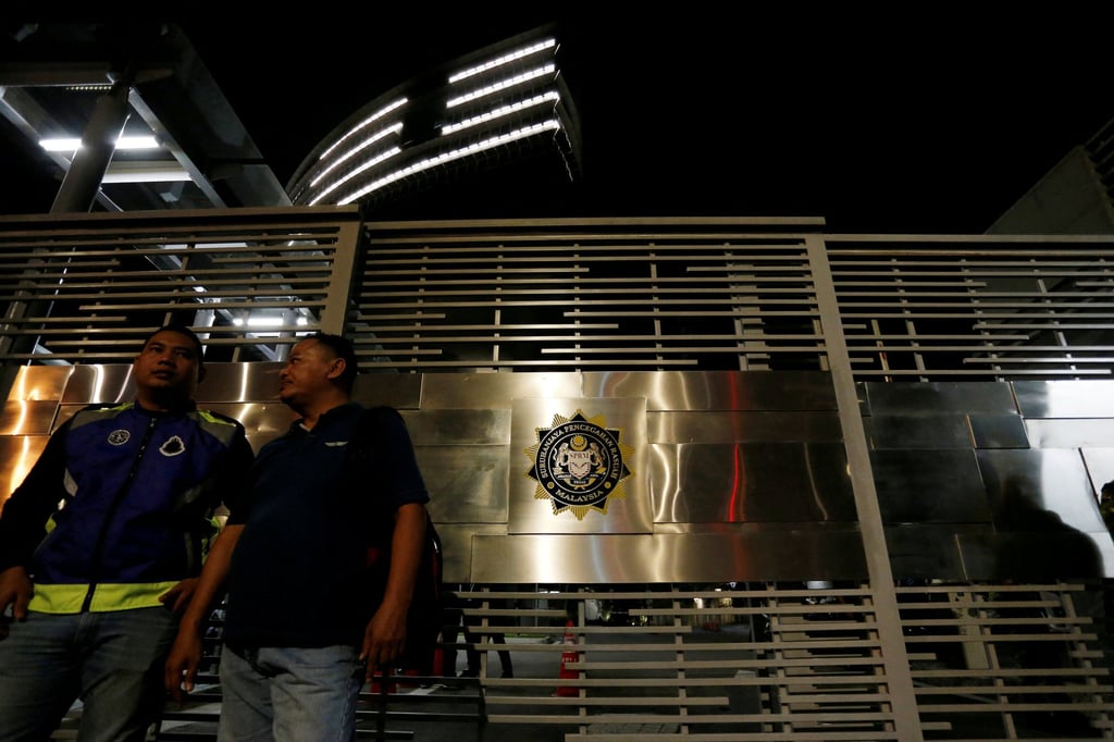 Police officers stand guard outside the Malaysian Anti-Corruption Commission (MACC) headquarters in Putrajaya, Malaysia, in 2018. Photo: Reuters