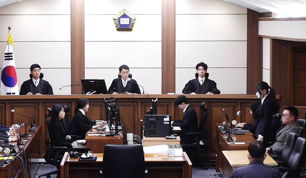 Kim Keon-hee (second from right, wearing a mask) in court last month during a verdict in her trial on corruption charges at the Seoul Central District Court. Photo: Yonhap/AFP