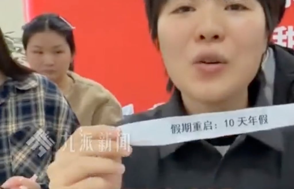 The lucky employee, surnamed Tao, shows off the tag denoting her prize. Photo: Sohu