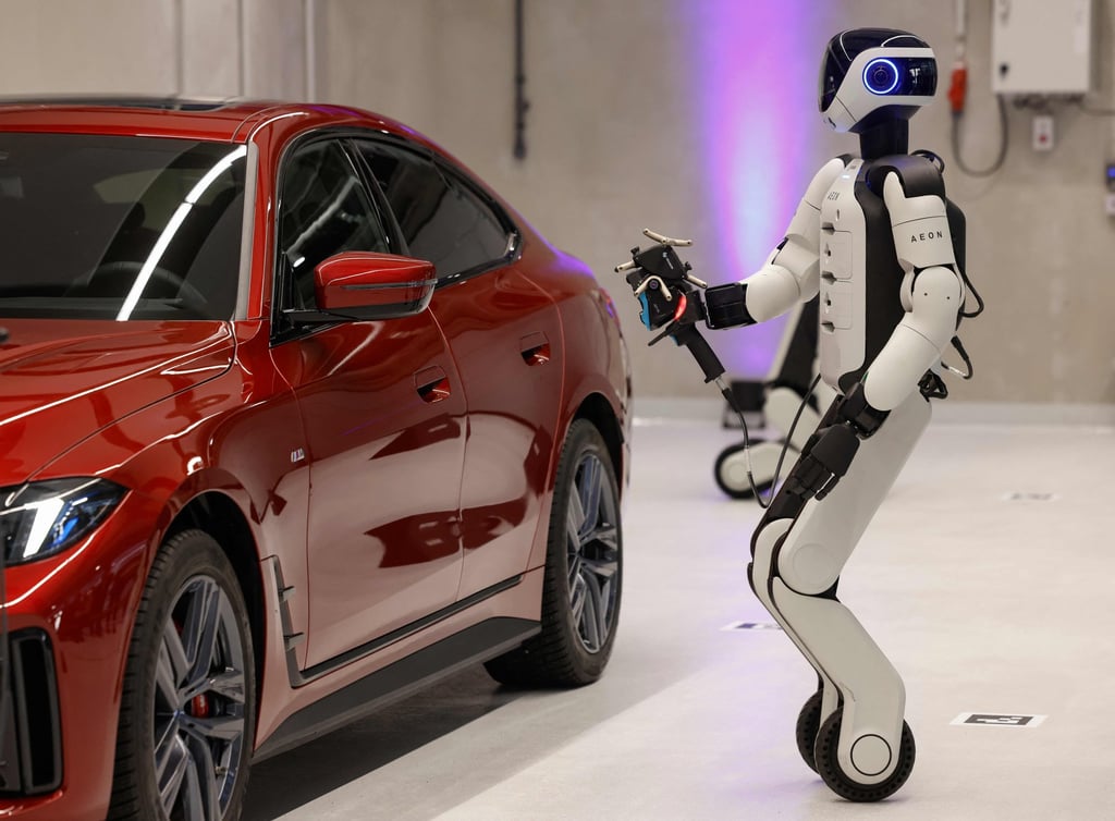 Aeon, a humanoid robotic created by the company Hexagon, works on a car with a laser scanner in Munich, Germany, on Friday. Photo: AFP
