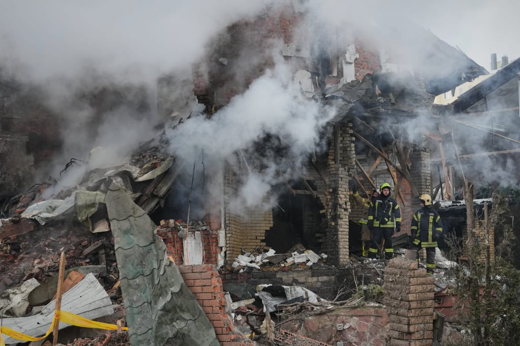 Firefighters tackle a blaze after a drone hit a residential building during a Russian air attack on Kyiv in February. Photo: AP