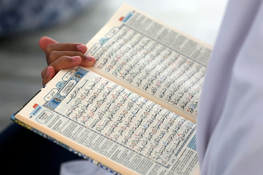 A pupil learns to read Arabic last month during a Koran memorisation lesson in Indonesia. Photo: EPA