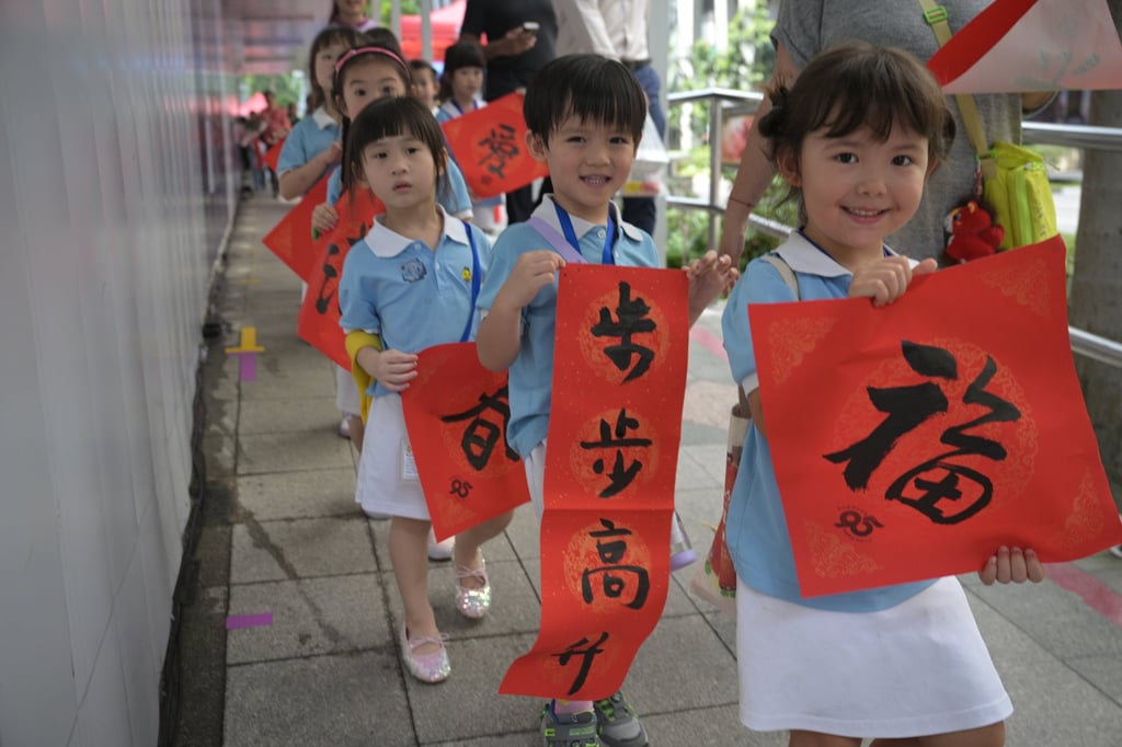Children show calligraphy works they have received as part of Chinese New Year celebrations, in Singapore on January 29. Singapore’s total fertility rate plunged to a record low of 0.87 in 2025. Photo: Xinhua