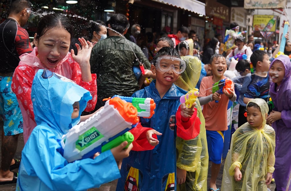 People splash water during Songkran at Kowloon City. Photo: Sam Tsang