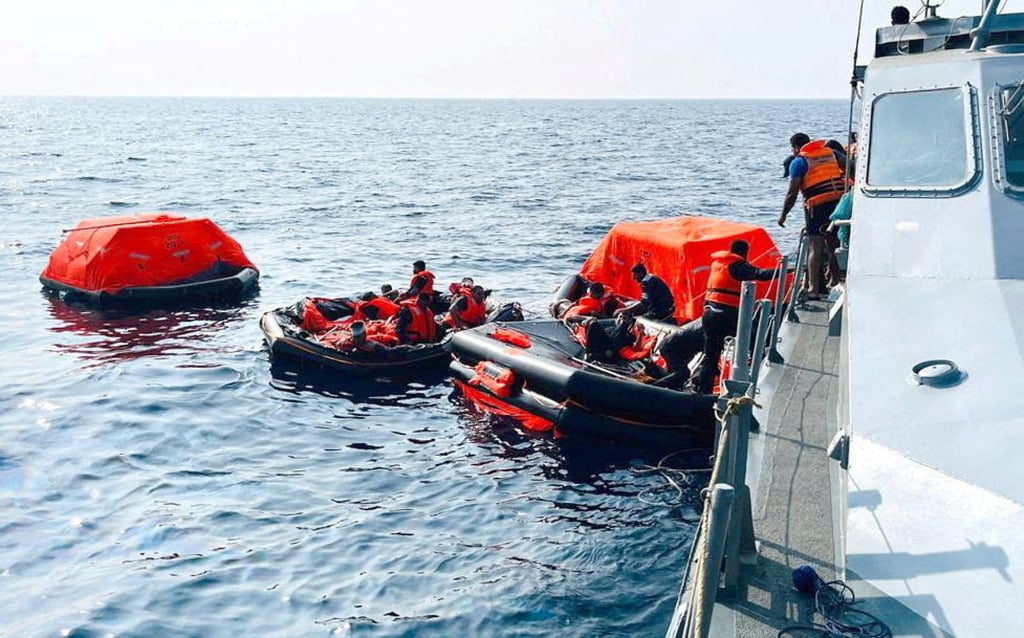 Sri Lanka Navy personnel assist Iranian sailors after responding to a distress call from the IRIS Dena, which later sank, with dozens dead, on Wednesday. Photo: Handout via Reuters